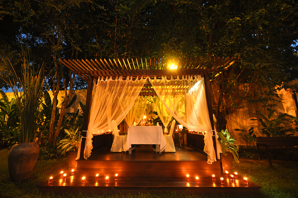 A candlelit dinner table set for two
